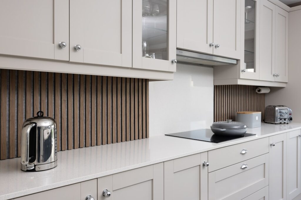 a-kitchen-with-white-cabinets-and-a-stove-top-oven-dpuf9g-3iyo Acoustic wall panels are specialized materials designed to absorb, diffuse, and minimize sound reflections in various settings.